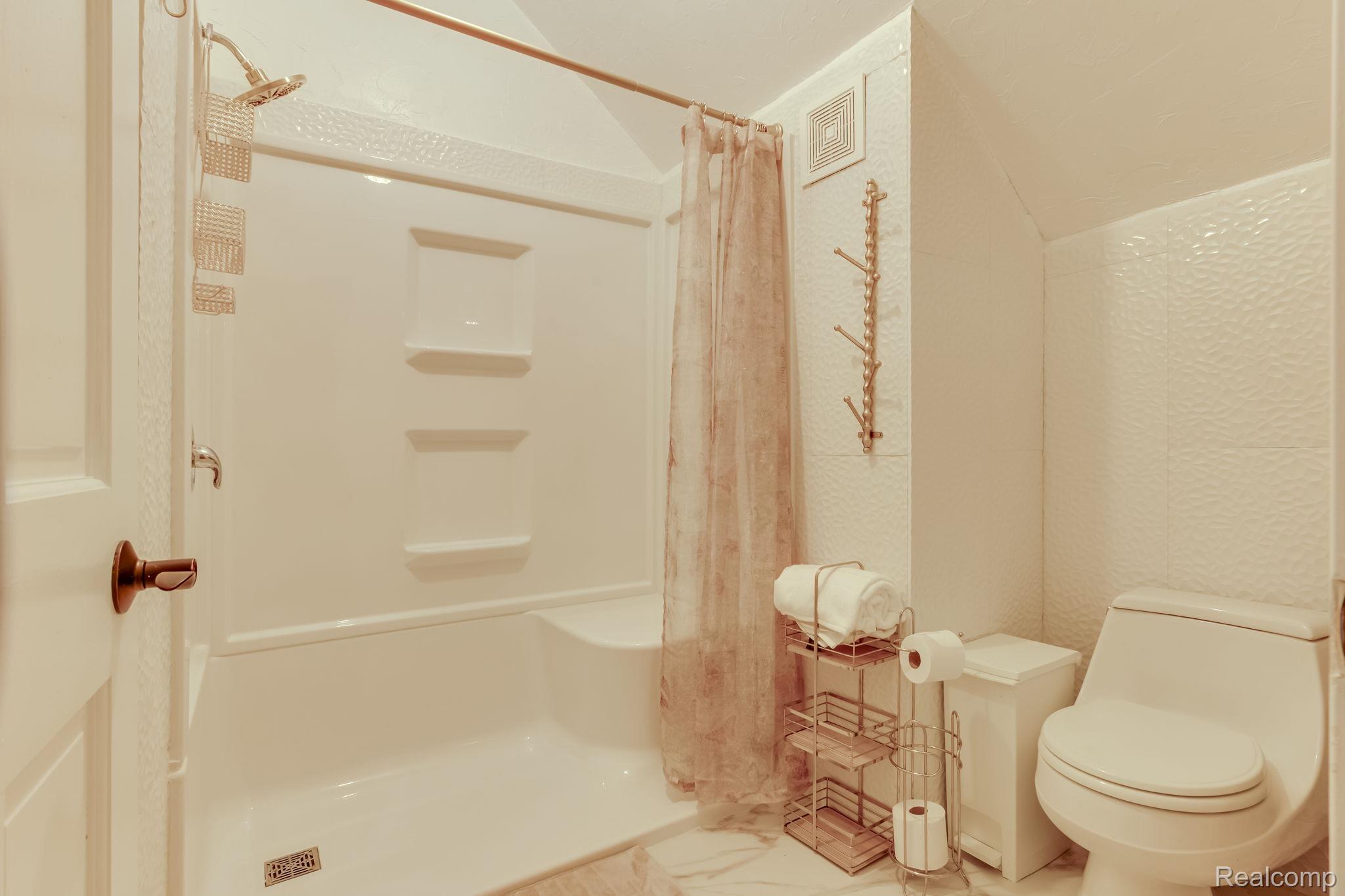 2400 North Lakeshore Road Carsonville, MI 48419 - Photo 11 of 33 Full bath featuring a shower stall and lofted ceiling