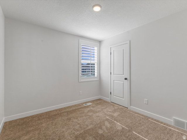 11759 South Watercourse Road South Jordan, UT 84009 - Photo 15 of 33 Neutral-toned room featuring plush carpet flooring