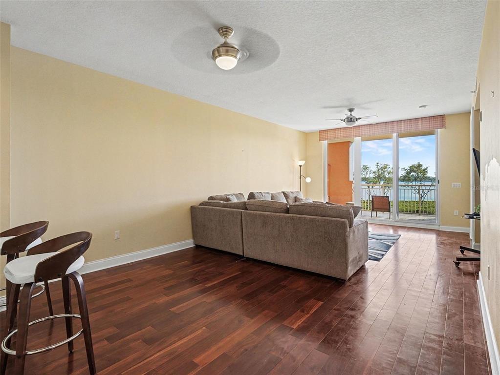 611 Riviera Dunes Way, Unit 102 Palmetto, FL 34221 - Photo 14 of 34 a living room with furniture and a large window