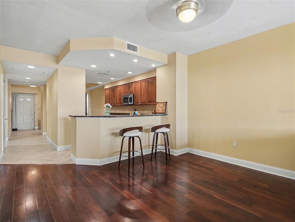 611 Riviera Dunes Way, Unit 102 Palmetto, FL 34221 - Photo 15 of 34 a kitchen with stainless steel appliances a refrigerator and a table