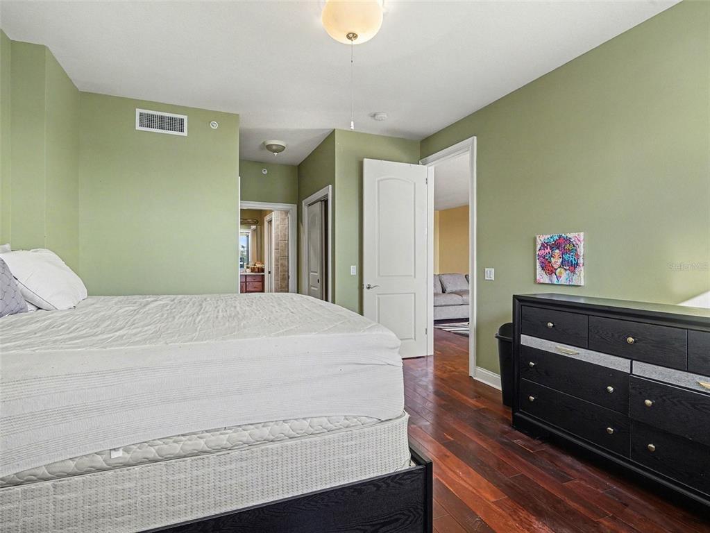 611 Riviera Dunes Way, Unit 102 Palmetto, FL 34221 - Photo 18 of 34 a bedroom with a bed and a dresser