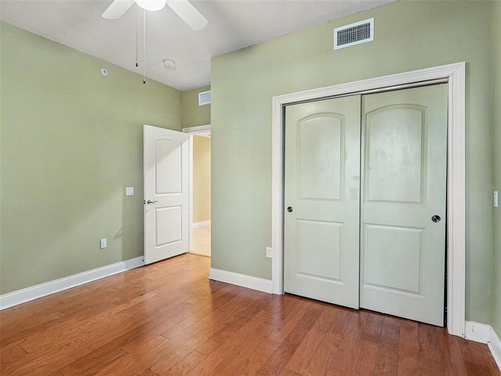 611 Riviera Dunes Way, Unit 102 Palmetto, FL 34221 - Photo 21 of 34 a view of an empty room with wooden floor