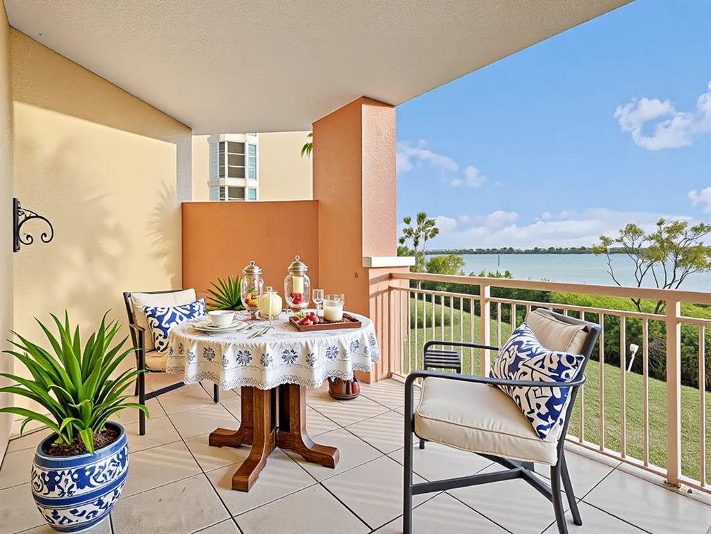 611 Riviera Dunes Way, Unit 102 Palmetto, FL 34221 - Photo 28 of 34 a roof deck with table and chairs