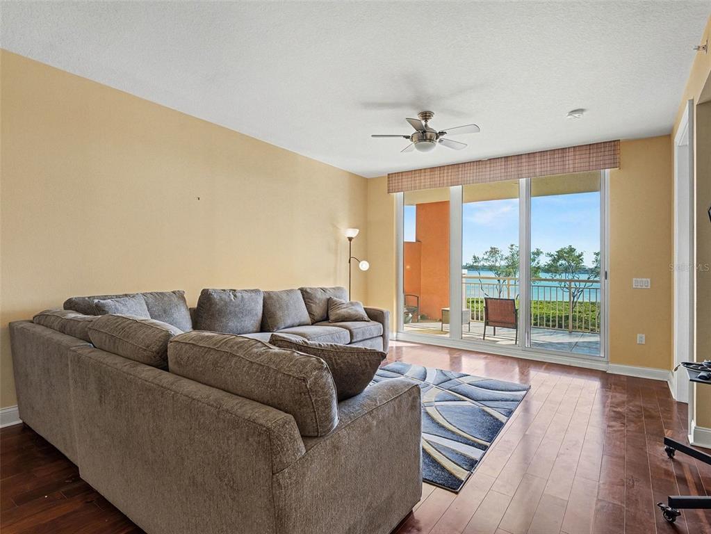 611 Riviera Dunes Way, Unit 102 Palmetto, FL 34221 - Photo 3 of 16 a living room with furniture and a large window