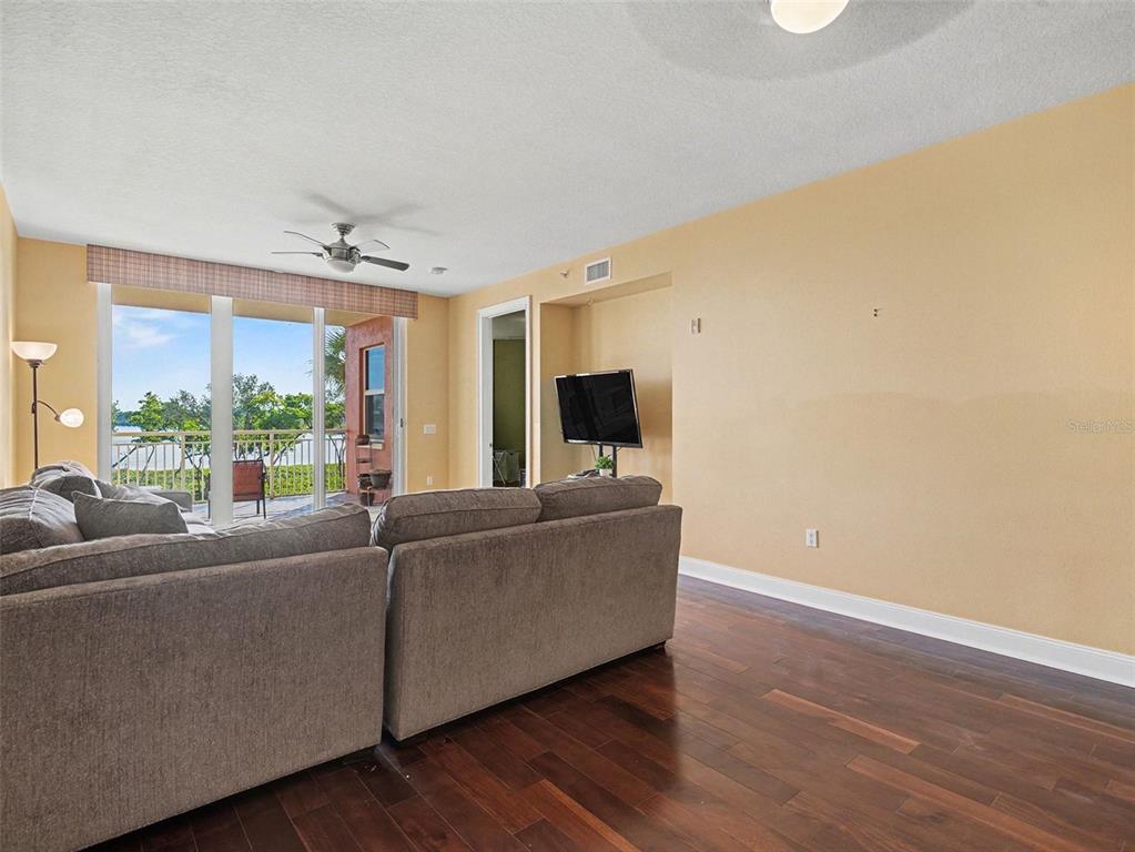 611 Riviera Dunes Way, Unit 102 Palmetto, FL 34221 - Photo 5 of 34 a living room with furniture and a large window
