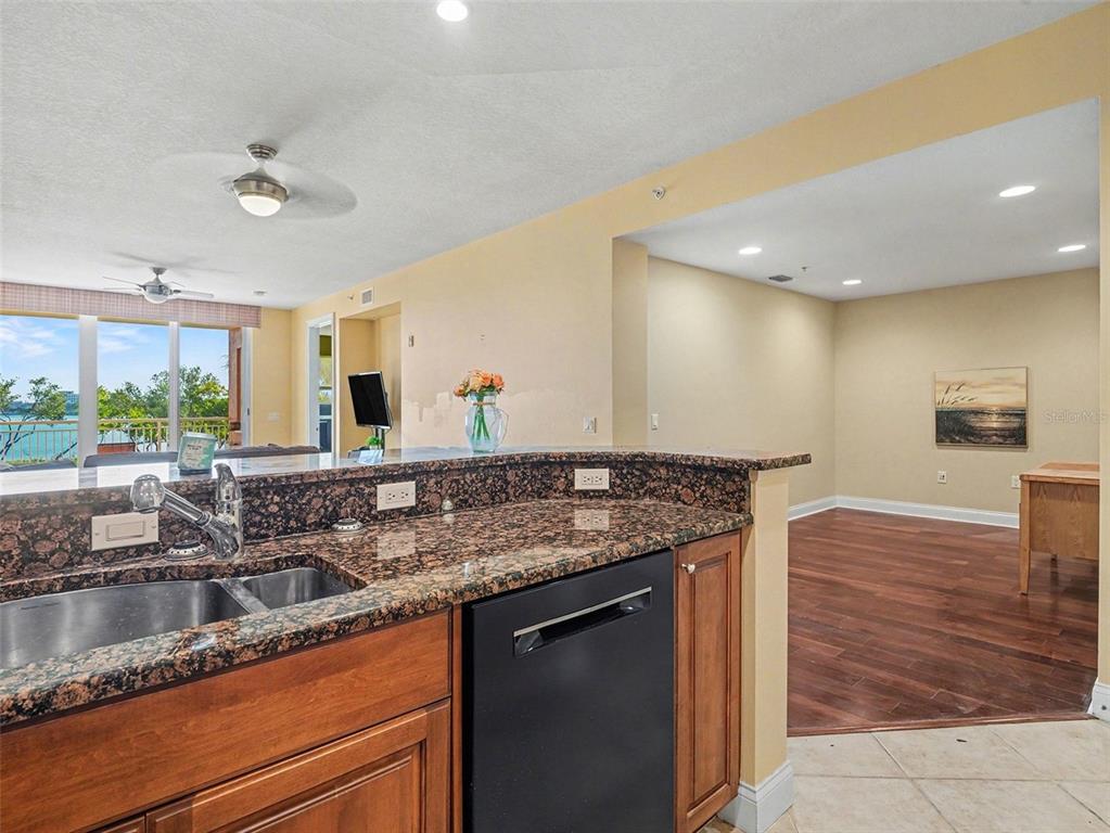 611 Riviera Dunes Way, Unit 102 Palmetto, FL 34221 - Photo 5 of 16 a kitchen with stainless steel appliances granite countertop a sink and a counter space
