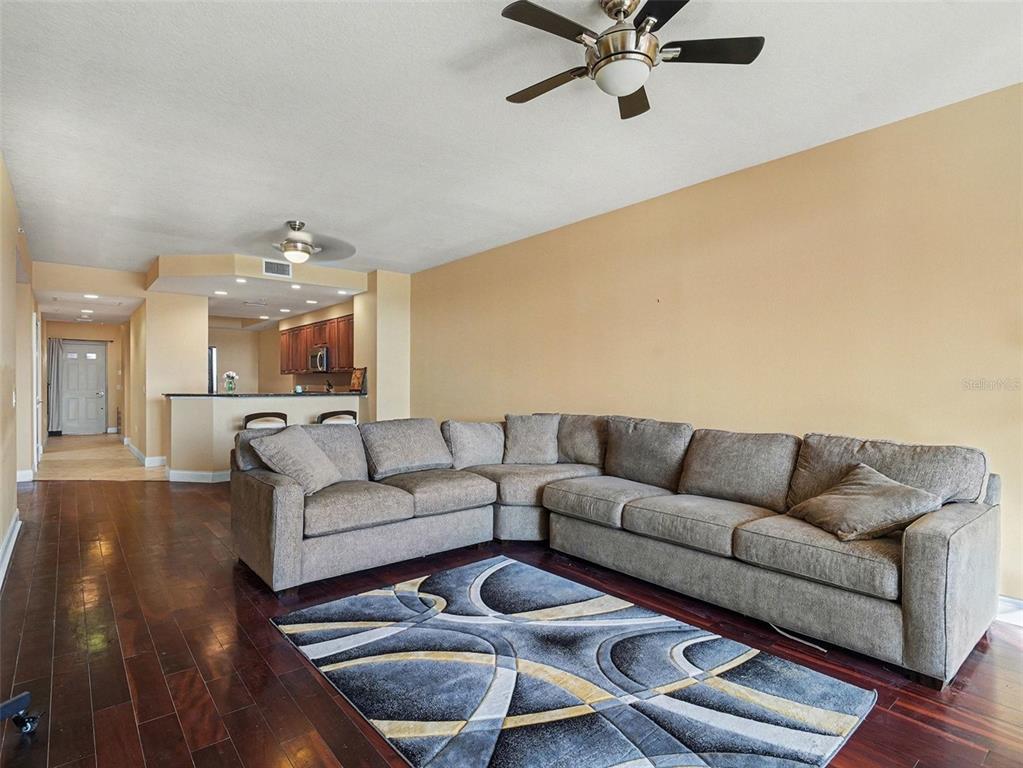 611 Riviera Dunes Way, Unit 102 Palmetto, FL 34221 - Photo 8 of 34 a living room with furniture and a chandelier