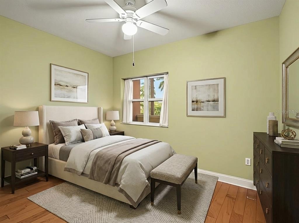 611 Riviera Dunes Way, Unit 102 Palmetto, FL 34221 - Photo 8 of 16 a bedroom with a bed and a window