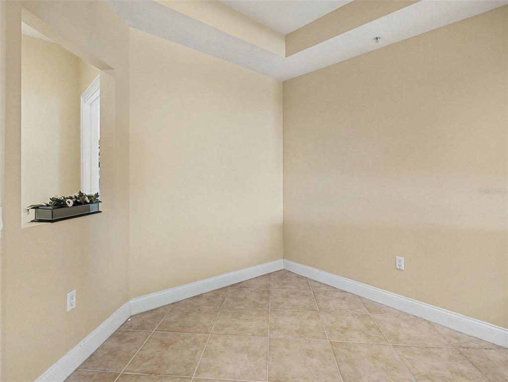 611 Riviera Dunes Way, Unit 102 Palmetto, FL 34221 - Photo 9 of 34 an empty room with a door