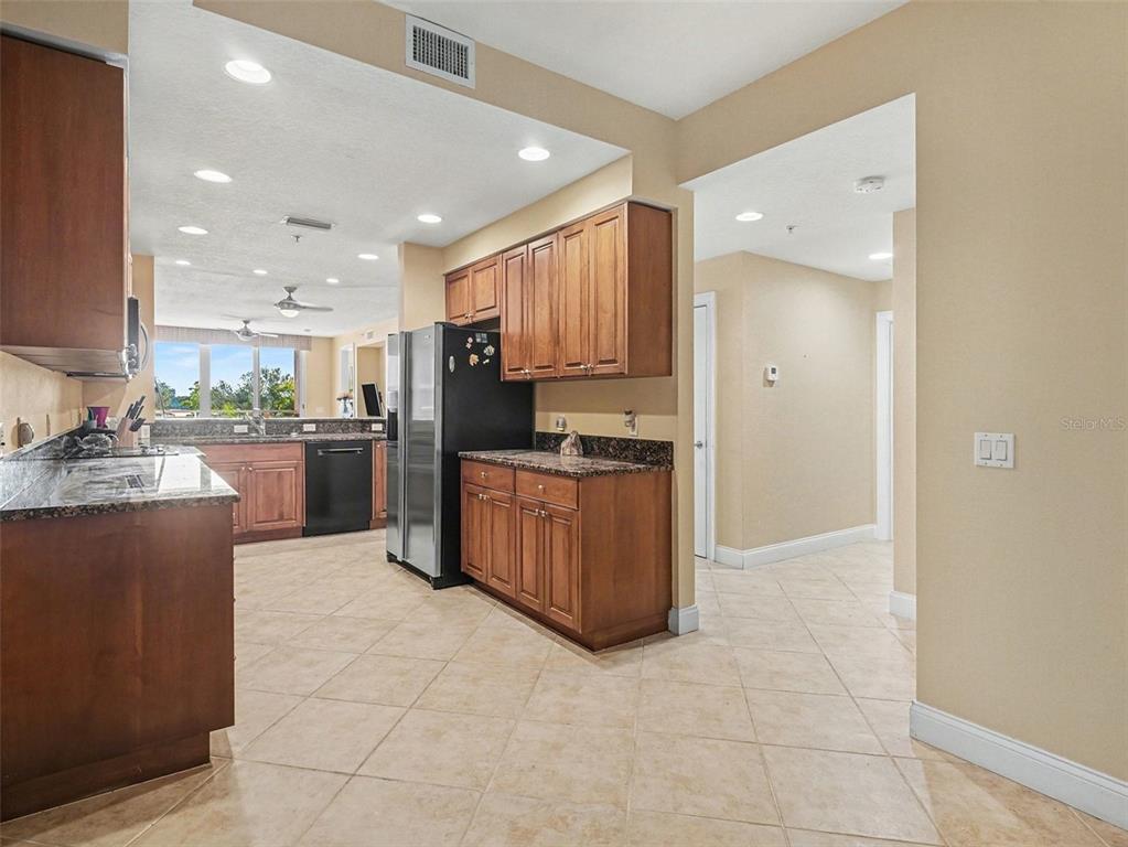 611 Riviera Dunes Way, Unit 102 Palmetto, FL 34221 - Photo 10 of 34 a kitchen with stainless steel appliances granite countertop a stove refrigerator and a sink
