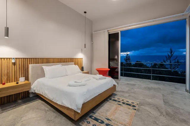 a bedroom with a bed and view of bathroom
