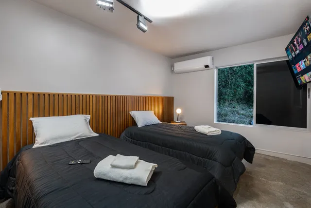 a bedroom with bed couch and window