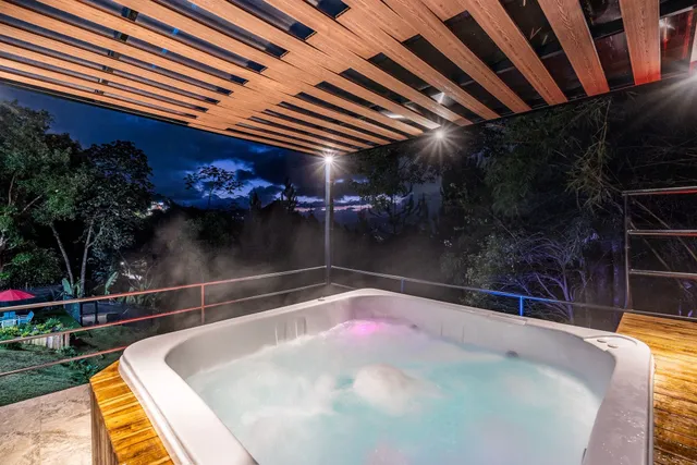 a bathroom with a granite countertop shower a sink and a mirror