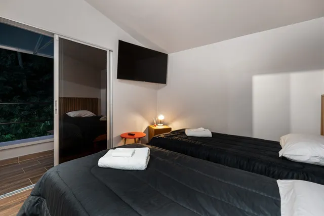 a bedroom with furniture and a large window