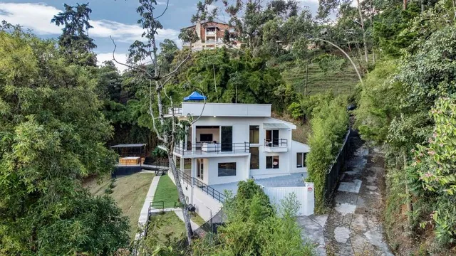 an aerial view of a house with a yard