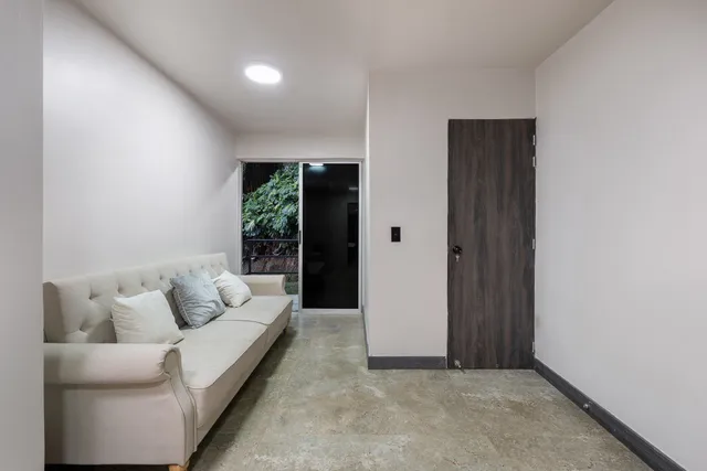 a living room with furniture and white walls