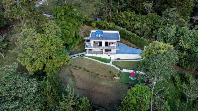 a view of a house with mountains in the background