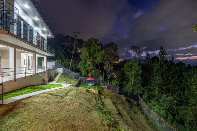 a view of a patio with a table and chairs under an umbrella