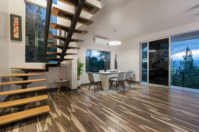 a view of a patio with table and chairs with wooden floor and a potted plant