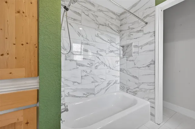 a bathroom with a bathtub and a shower