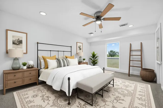 a bedroom with a bed a chandelier and a couch