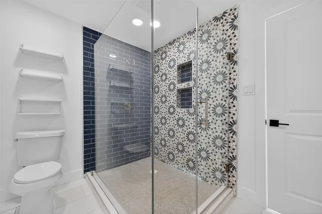 a bathroom with a toilet and shower