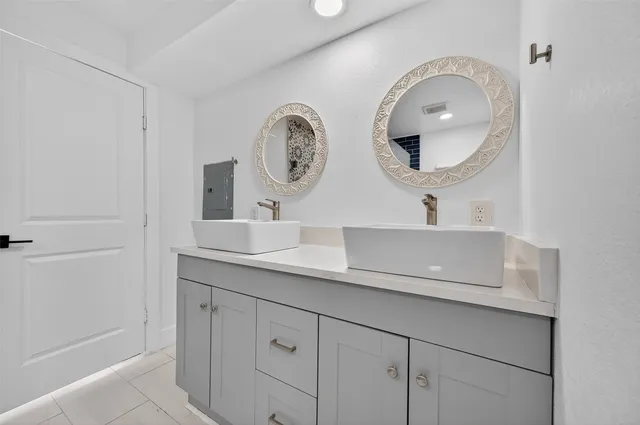 a bathroom with a granite countertop sink mirror and vanity