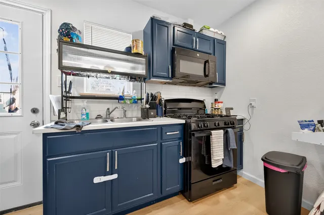 a kitchen with stainless steel appliances granite countertop a sink stove and microwave