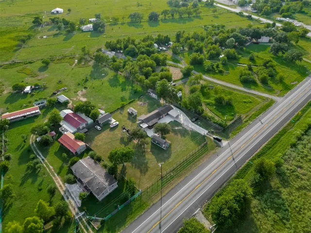 an aerial view of residential houses with outdoor space