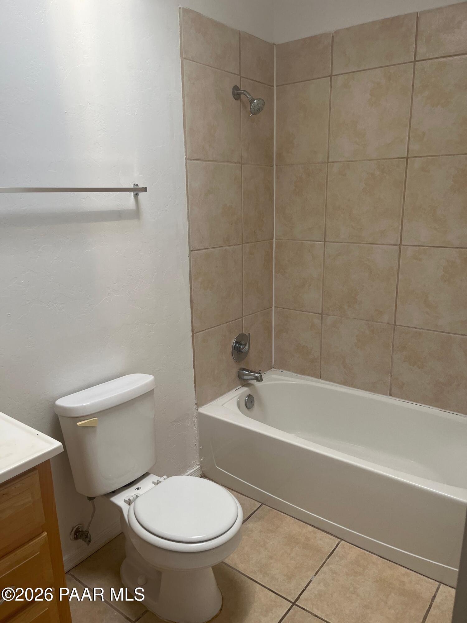 354 West Delano Street, Unit 1 Tucson, AZ 85705 - Photo 6 of 18 a white toilet and tub sitting next to a bathroom sink
