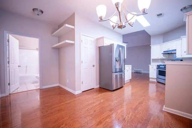 a view of a kitchen with furniture and wooden floor