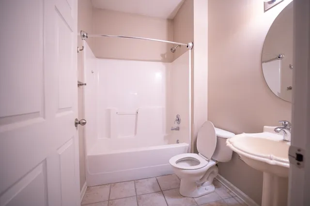 a bathroom with a toilet sink and shower