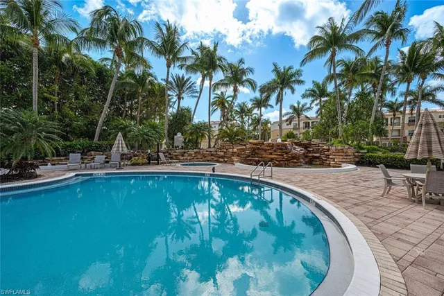 a swimming pool with outdoor seating and yard