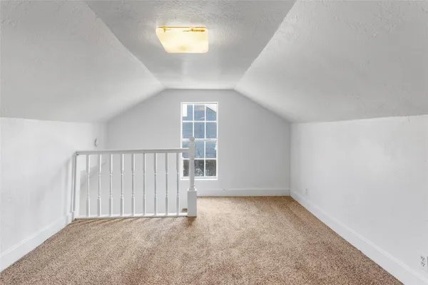 an empty room with a empty space and windows