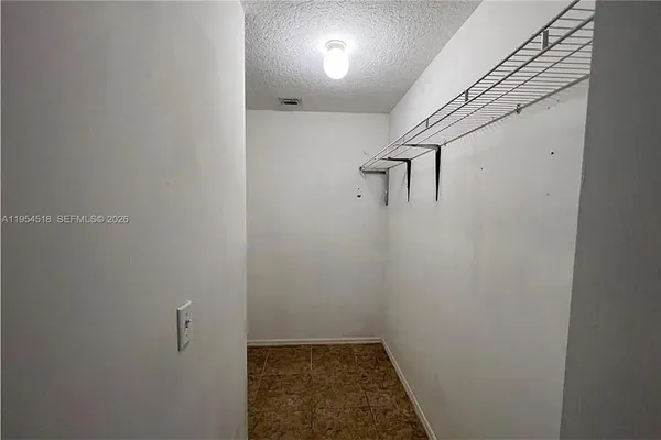 a bathroom with a sink a toilet a mirror and shower