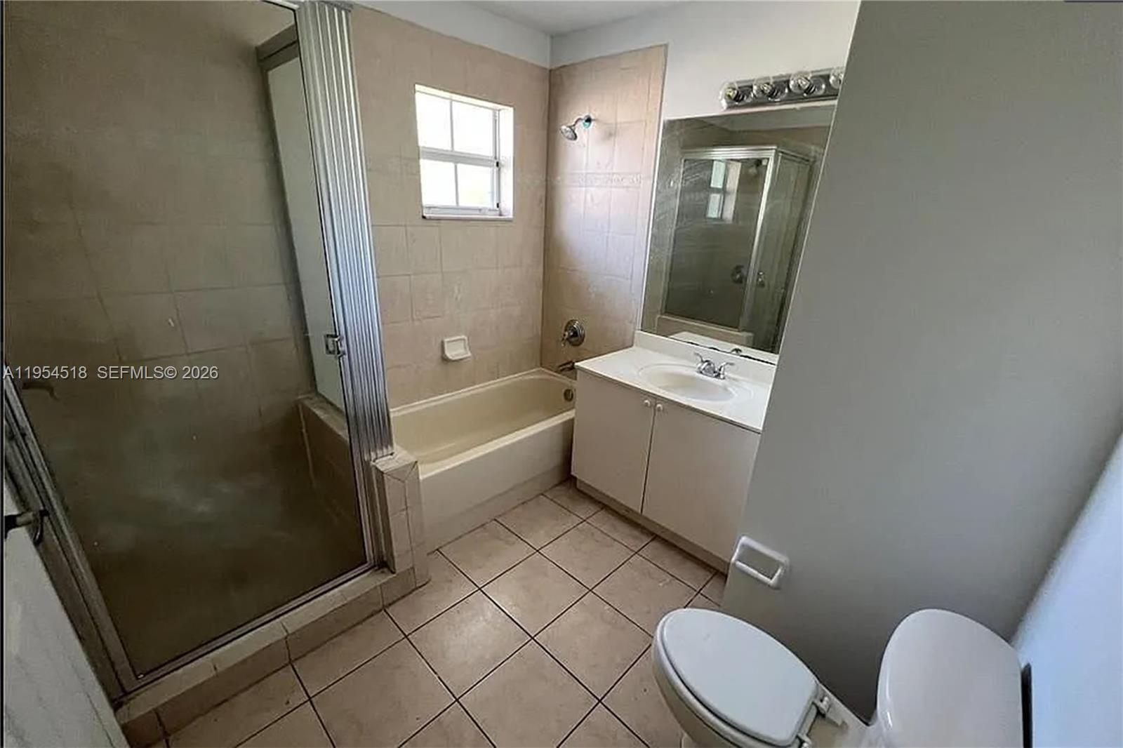 13990 Southwest 260th Street, Unit 13990 Homestead, FL 33032 - Photo 15 of 33 a bathroom with a sink a toilet a mirror and shower