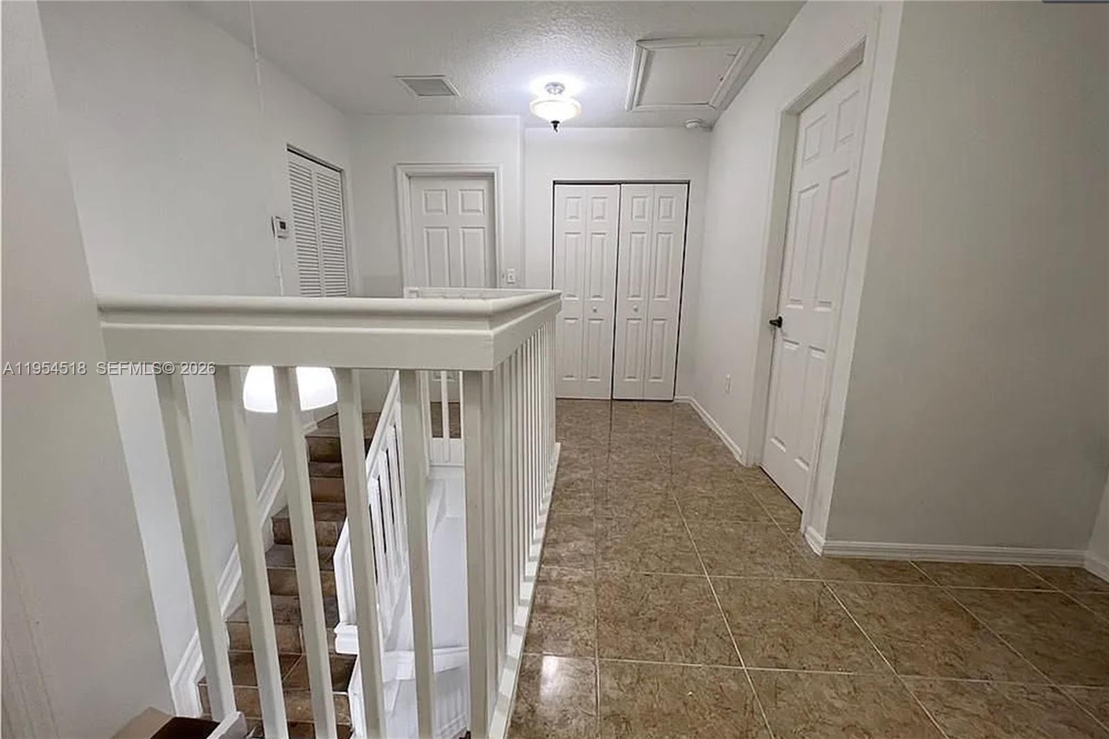 13990 Southwest 260th Street, Unit 13990 Homestead, FL 33032 - Photo 18 of 33 a view of a hallway with staircase