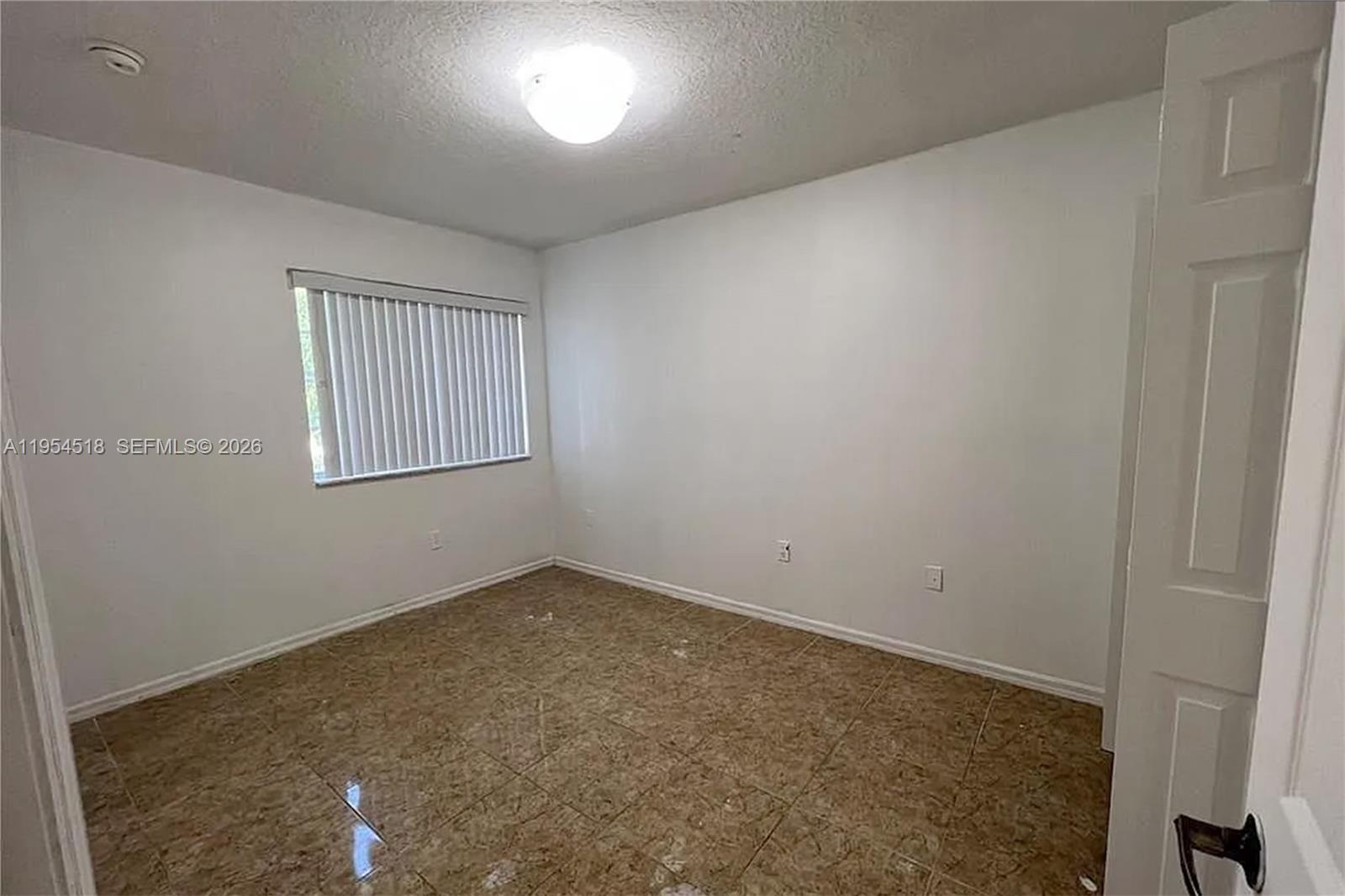 13990 Southwest 260th Street, Unit 13990 Homestead, FL 33032 - Photo 19 of 33 an empty room with windows