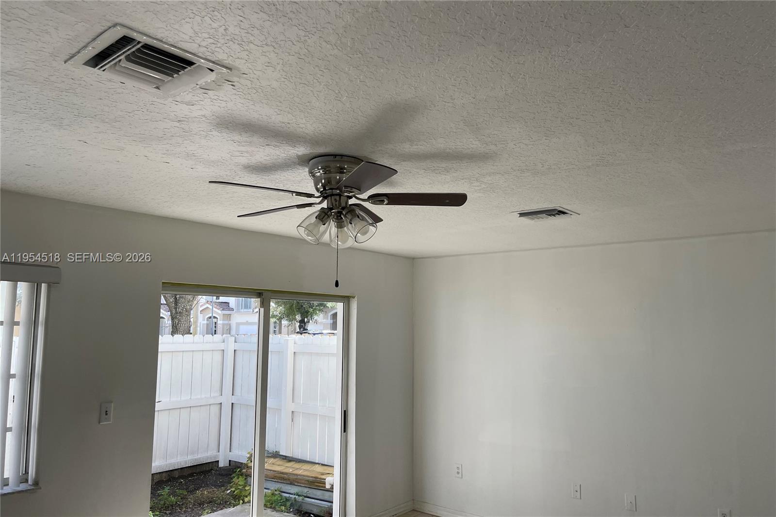 13990 Southwest 260th Street, Unit 13990 Homestead, FL 33032 - Photo 27 of 33 a view of an empty room with a window