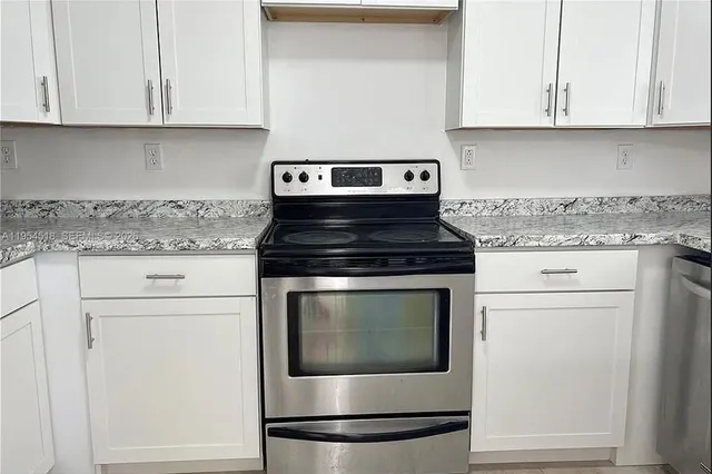 a stove top oven sitting inside of a kitchen
