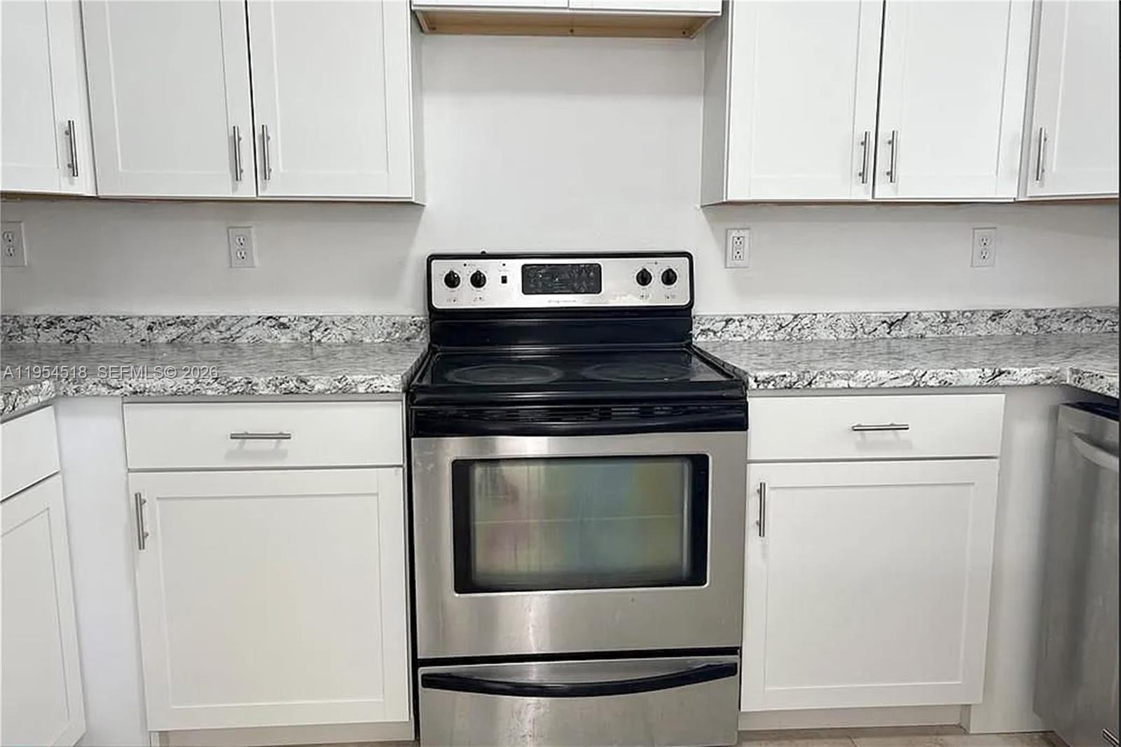 13990 Southwest 260th Street, Unit 13990 Homestead, FL 33032 - Photo 8 of 33 a stove top oven sitting inside of a kitchen