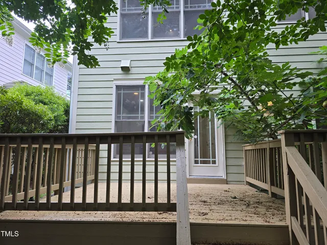 a view of a house with a small deck