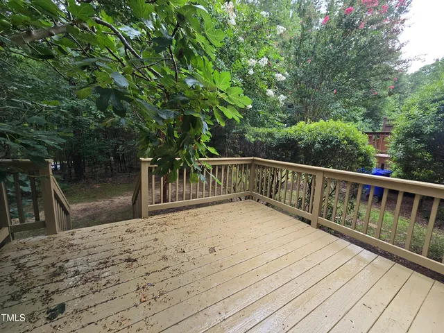 a view of balcony with wooden floor and fence