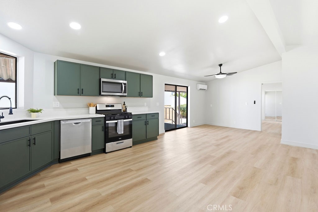 15181 Van Buren, Unit 262 Riverside, CA 92504 - Photo 13 of 48 a large kitchen with cabinets stainless steel appliances and a window