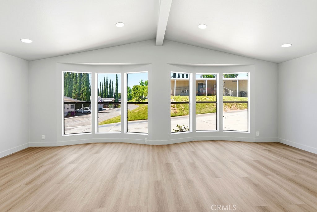 15181 Van Buren, Unit 262 Riverside, CA 92504 - Photo 15 of 48 an empty room with wooden floor and windows