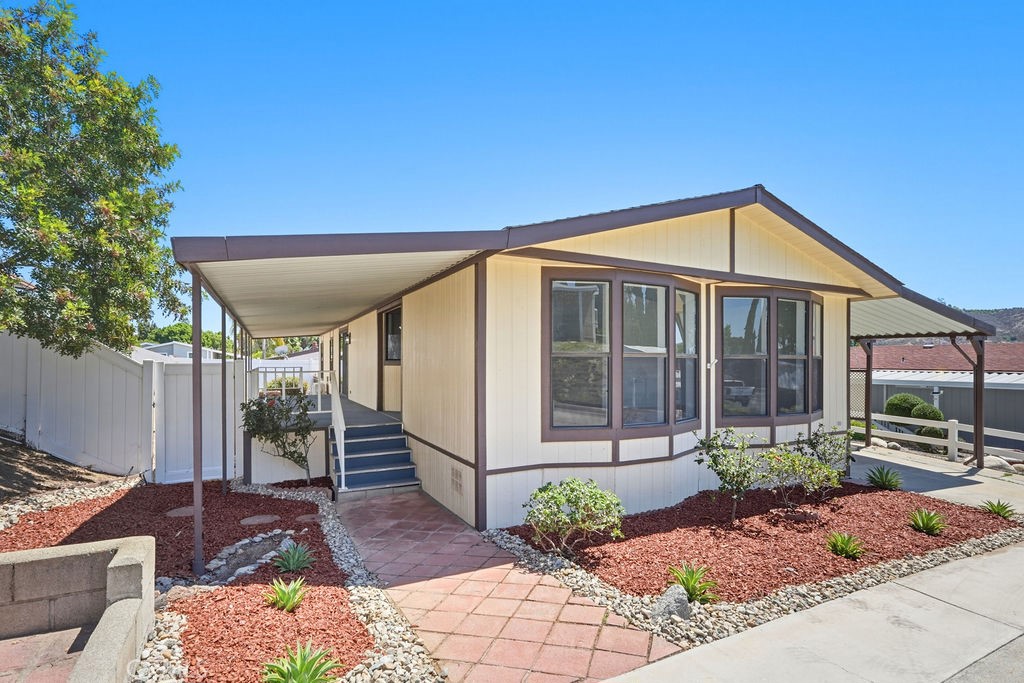 15181 Van Buren, Unit 262 Riverside, CA 92504 - Photo 2 of 48 a front view of a house with garden