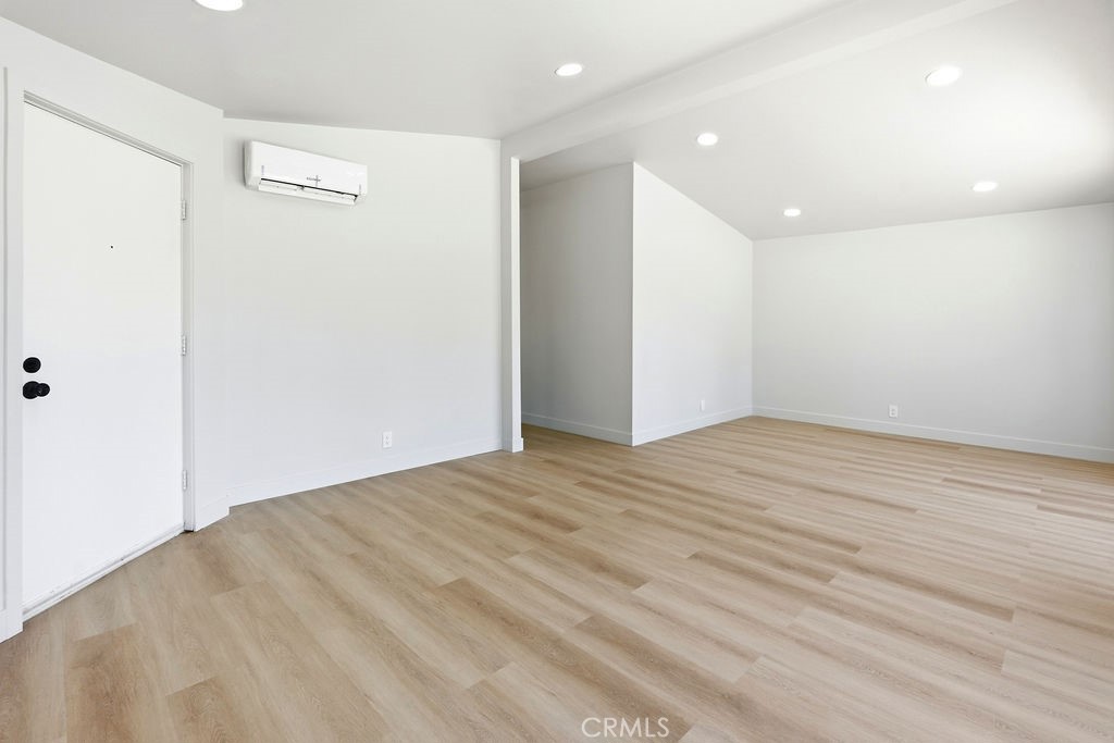 15181 Van Buren, Unit 262 Riverside, CA 92504 - Photo 23 of 48 an empty room with wooden floor and windows