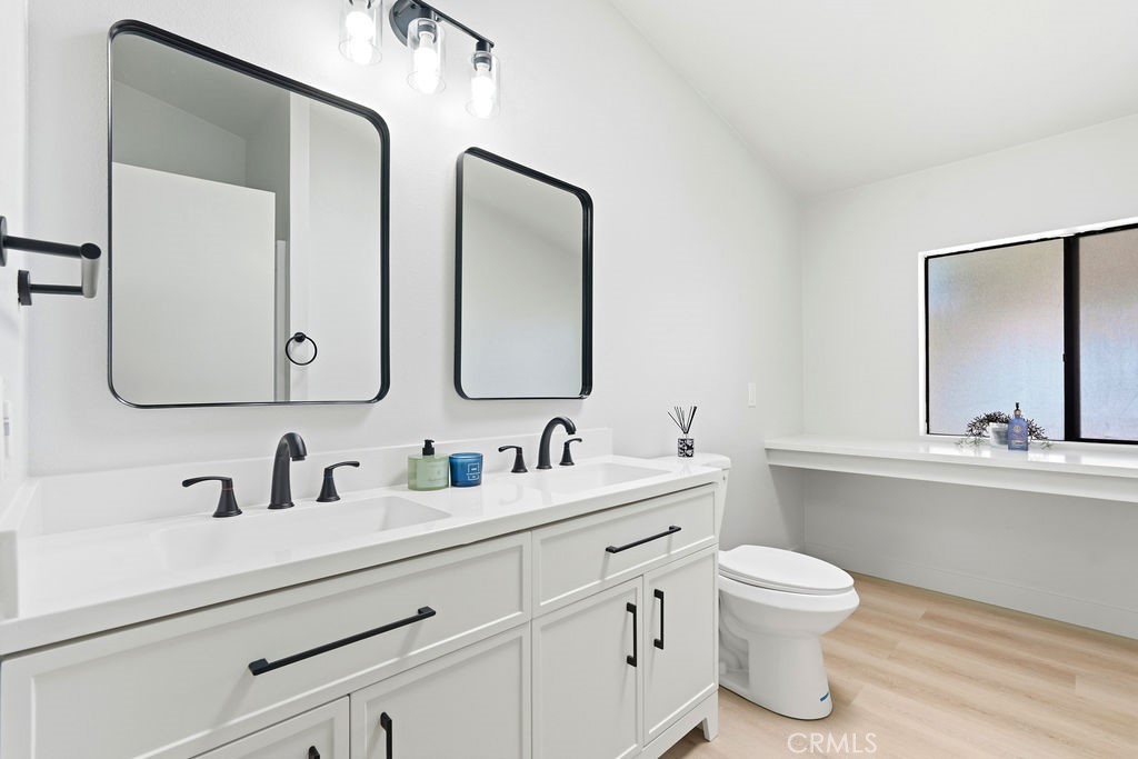 15181 Van Buren, Unit 262 Riverside, CA 92504 - Photo 26 of 48 a bathroom with a toilet sink and mirror