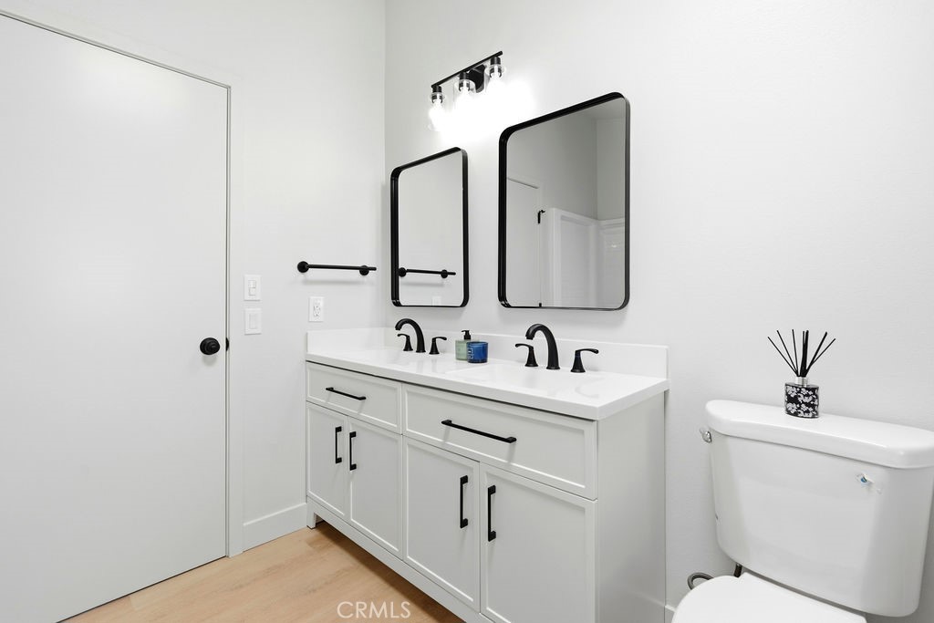 15181 Van Buren, Unit 262 Riverside, CA 92504 - Photo 27 of 48 a bathroom with a toilet sink and mirror