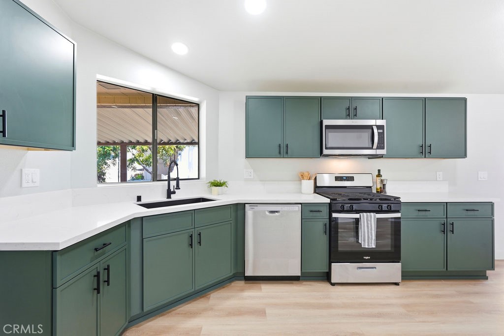 15181 Van Buren, Unit 262 Riverside, CA 92504 - Photo 7 of 48 a kitchen with a sink cabinets and stainless steel appliances